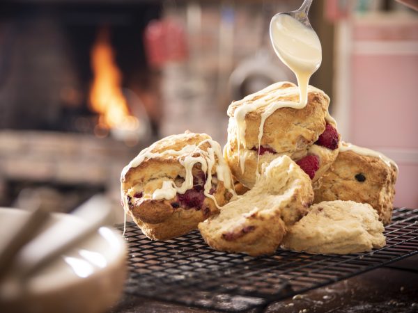 Drizzling white choc on rasp scones